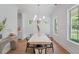 Elegant dining room featuring a light wood table, black chairs, wainscoting, and natural light at 5710 Barbary Coast Rd, Hollywood, SC 29449