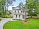 Beautiful two-story home with a double porch and a manicured lawn with mature trees at 5710 Barbary Coast Rd, Hollywood, SC 29449