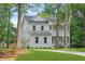 Charming two-story home featuring a double porch, manicured lawn, and a classic white facade at 5710 Barbary Coast Rd, Hollywood, SC 29449