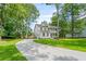 Stunning two-story home with long driveway, a double porch, and lush landscaping at 5710 Barbary Coast Rd, Hollywood, SC 29449