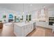 Open-concept kitchen featuring white cabinets, stainless steel appliances, and a large center island at 5710 Barbary Coast Rd, Hollywood, SC 29449