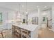 Bright kitchen featuring a large island with seating, white cabinets, and stainless steel appliances at 5710 Barbary Coast Rd, Hollywood, SC 29449