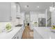 Modern kitchen with stainless appliances, white cabinets and countertops, and hardwood flooring at 5710 Barbary Coast Rd, Hollywood, SC 29449