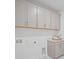 Clean and modern laundry room featuring gray cabinets and marble countertops at 5710 Barbary Coast Rd, Hollywood, SC 29449