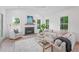 Airy living room with white walls, a fireplace, comfortable seating, and ample natural light at 5710 Barbary Coast Rd, Hollywood, SC 29449
