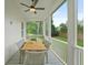 Inviting screened-in porch with outdoor dining set and serene views of the lush backyard, perfect for relaxation at 5710 Barbary Coast Rd, Hollywood, SC 29449