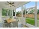 Relaxing screened-in porch features an outdoor dining area, ceiling fan and views of the lush backyard at 5710 Barbary Coast Rd, Hollywood, SC 29449