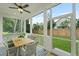 Relaxing screened-in porch features an outdoor dining area, ceiling fan and views of the lush backyard at 5710 Barbary Coast Rd, Hollywood, SC 29449