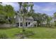 Lovely backyard view featuring a screened porch, deck, and mature trees offering shade and privacy at 633 Stono Edge Dr, Charleston, SC 29412
