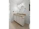 Bright bathroom features a double sink vanity with a granite countertop and round mirrors at 633 Stono Edge Dr, Charleston, SC 29412