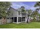 Back of the home features a spacious yard, screened porch, outdoor stairs and lush landscaping at 633 Stono Edge Dr, Charleston, SC 29412