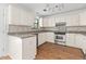 Bright kitchen features granite counters, white cabinets, and stainless steel appliances at 633 Stono Edge Dr, Charleston, SC 29412