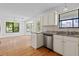 Living room with wood floors leading to kitchen with granite countertops at 633 Stono Edge Dr, Charleston, SC 29412