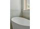 Close up of white standalone tub and wainscotting next to a window at 743 Hills St, Mount Pleasant, SC 29464