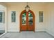 Close-up of an arched wood front door and sidelight windows at 743 Hills St, Mount Pleasant, SC 29464