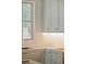 Bright kitchen featuring custom cabinets, gold hardware, and natural light from window at 743 Hills St, Mount Pleasant, SC 29464