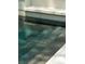 Steps leading into a pool with textured surface, providing a safe and stylish entry into the refreshing water at 743 Hills St, Mount Pleasant, SC 29464