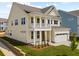 Charming two-story home featuring a welcoming porch, attached garage, and manicured lawn at 791 Maynard Ln, Summerville, SC 29486