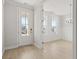Bright foyer with white door, and light wood floors and view to formal dining room at 791 Maynard Ln, Summerville, SC 29486