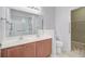 Double vanity in a bathroom with a large mirror, shower, and accessible walk-in closet at 810 Bibury Ct, Charleston, SC 29414
