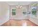 Dining room features hardwood floors, chandelier lighting and bright natural light at 810 Bibury Ct, Charleston, SC 29414