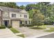 Inviting townhome showcasing a well-kept lawn, lush landscaping, and classic architectural details at 810 Bibury Ct, Charleston, SC 29414