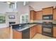 Kitchen with black appliances, granite countertops, and an open view to the living room at 810 Bibury Ct, Charleston, SC 29414