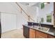 Bright kitchen featuring granite countertops, stainless steel appliances, and easy access to stairs and the outside at 810 Bibury Ct, Charleston, SC 29414