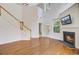 Spacious living room with a fireplace, hardwood floors, and adjacent staircase at 810 Bibury Ct, Charleston, SC 29414