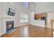 Cozy living room with a fireplace, hardwood floors, and a glimpse into the kitchen at 810 Bibury Ct, Charleston, SC 29414