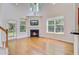 Well-lit living room with hardwood floors, fireplace, and numerous windows at 810 Bibury Ct, Charleston, SC 29414