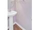Pedestal sink in a modern half bathroom with hardwood-style floors and neutral walls at 810 Bibury Ct, Charleston, SC 29414