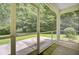 Screened porch with view of green lawn and lush trees at 810 Bibury Ct, Charleston, SC 29414