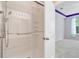 Accessible shower featuring a glass door, handheld shower head, and built-in shelving at 810 Bibury Ct, Charleston, SC 29414