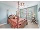 Charming bedroom with a four-poster bed, ceiling fan and bright natural light at 8327 Childs Cove Cir, North Charleston, SC 29418