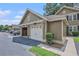 Detached garages with white doors and adjacent parking spaces at 8327 Childs Cove Cir, North Charleston, SC 29418