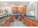 Well-equipped kitchen with stainless steel appliances, wood cabinets, and granite countertops at 8327 Childs Cove Cir, North Charleston, SC 29418