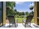 A relaxing place to enjoy the outdoor view from these rocking chairs and hanging plants at 8327 Childs Cove Cir, North Charleston, SC 29418