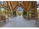 Beautiful open pavilion with fireplace, seating, and wood beam ceiling is great for relaxing and entertaining at 8327 Childs Cove Cir, North Charleston, SC 29418