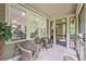 Covered porch with wicker furniture, ideal for outdoor relaxation at 8327 Childs Cove Cir, North Charleston, SC 29418