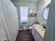 Well-lit bathroom with a wood-look floor and traditional design elements for a comfortable space at 837 Club Cottage Rd, Edisto Island, SC 29438