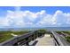 Inviting wooden boardwalk leading to the beach, enhanced by coastal vegetation and scenic ocean views at 837 Club Cottage Rd, Edisto Island, SC 29438