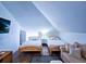 Bright bedroom features two twin beds, wood flooring, and a mounted flat screen at 837 Club Cottage Rd, Edisto Island, SC 29438