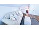Comfortable bedroom features a sofa, bed, wood flooring, and bright, white walls at 837 Club Cottage Rd, Edisto Island, SC 29438