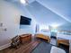 Bright bedroom features two twin beds, wood flooring, and a mounted flat screen at 837 Club Cottage Rd, Edisto Island, SC 29438