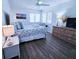 Inviting bedroom with coastal decor, a comfortable bed, and large windows providing natural light at 837 Club Cottage Rd, Edisto Island, SC 29438