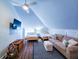 Spacious bedroom with multiple beds, cozy sofa, TV, hardwood floor and a ceiling fan at 837 Club Cottage Rd, Edisto Island, SC 29438