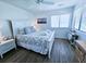 Cozy bedroom with a comfortable bed, coastal-themed decor, and soft natural lighting, perfect for relaxation at 837 Club Cottage Rd, Edisto Island, SC 29438