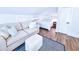 Comfortable bedroom features a sofa, bed, wood flooring, and bright, white walls at 837 Club Cottage Rd, Edisto Island, SC 29438