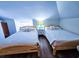 Cozy bedroom features two twin beds, wood flooring, and a skylight at 837 Club Cottage Rd, Edisto Island, SC 29438